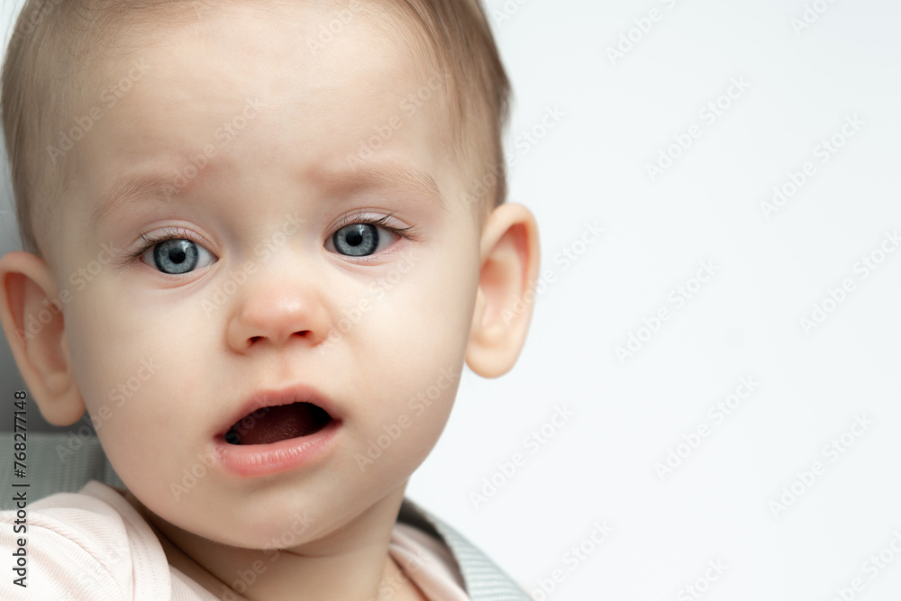 a baby is crying while sitting in a chair