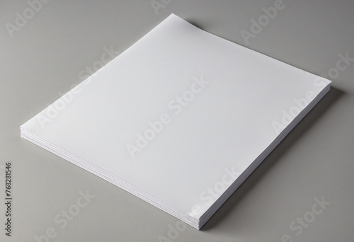White paper isolated on a gray, changeable background that is blank in portrait A4 size.  photo