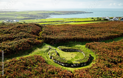 Holyhead Mountain Ty Mawr Hut Circles. Part of Prehistoric Neolithic through Iron Age house settlement stone foundations. Anglesey, Wales. View south