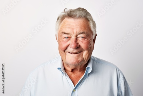 Portrait of a happy senior man on grey background. Studio shot.