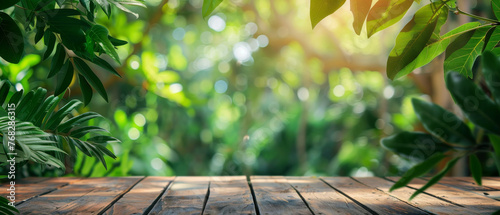 A textured wooden platform offering the illusion of being in the midst of tropical lush green leaves and plants with radiant sunlight