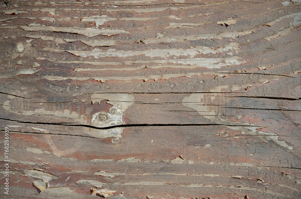 Naklejka premium background and texture of old worn brown wood, unpainted and with cracks