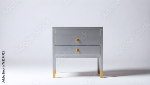 White modern two-drawer dresser with gold handles and legs against a plain light background