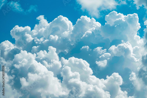 photograph as a pattern of fluffy white clouds against a bright blue sky, evoking a sense of calm and openness 