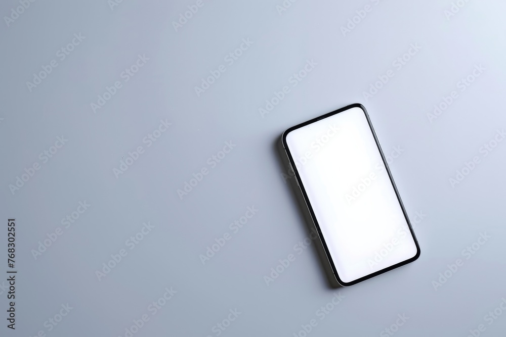 A direct aerial view of a modern smartphone on a solid gray background, signifying high-tech and digital communication A direct aerial view of a modern smartphone on a solid gray background, signifying high-tech and digital communication