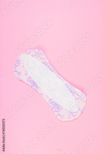 Sanitary pad on pink background. Daily feminine hygiene product. Menstruation concept.