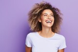 Portrait of beautiful young woman with afro hairstyle on violet background