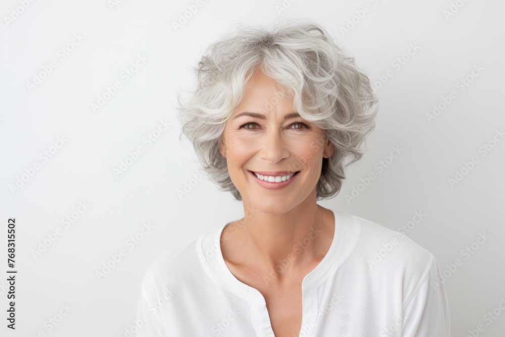 Portrait of a smiling senior woman with grey hair, isolated on white background