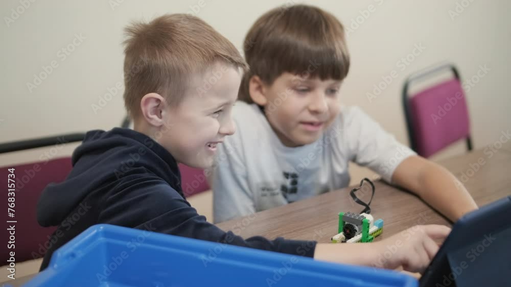 Children engage in STEM learning activities, assembling robotics kits ...