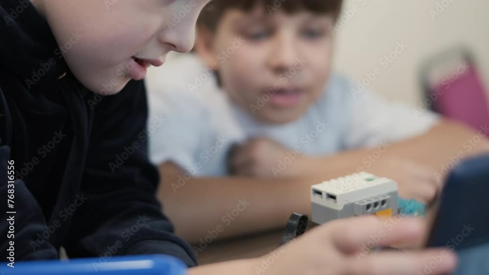 Children engage in STEM learning activities, assembling robotics kits ...