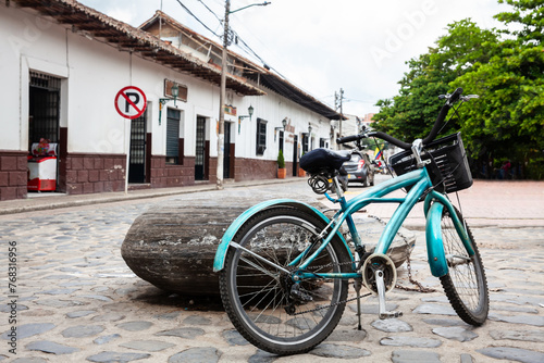 Vintage blue bike parked at the beautiful streets around the central square of the Heritage Town of Guaduas located in the Department of Cundinamarca in Colombia.