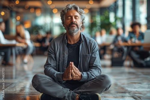 A man is peacefully meditating on the street in a city, sitting crosslegged on the concrete floor with his eyes closed, finding leisure and relaxation in the urban environment photo