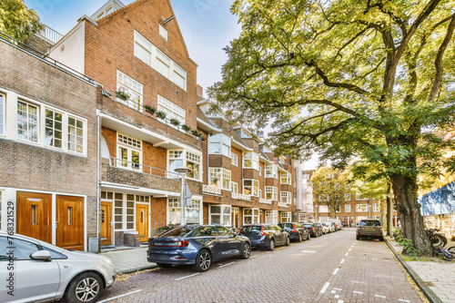 Residential street with modern apartments and parked cars photo