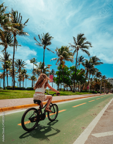 girl riding a bicycle summer Miami Beach Florida 