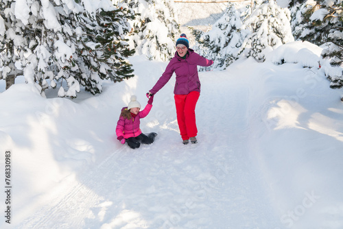 A Mother and Daughter's Blissful Run Along a Snowy Winter Path
