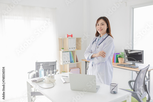 smart female doctor do work in hospital, she stand up and cross arm, she feeling happy in relax time, she ready to service and treatment patient