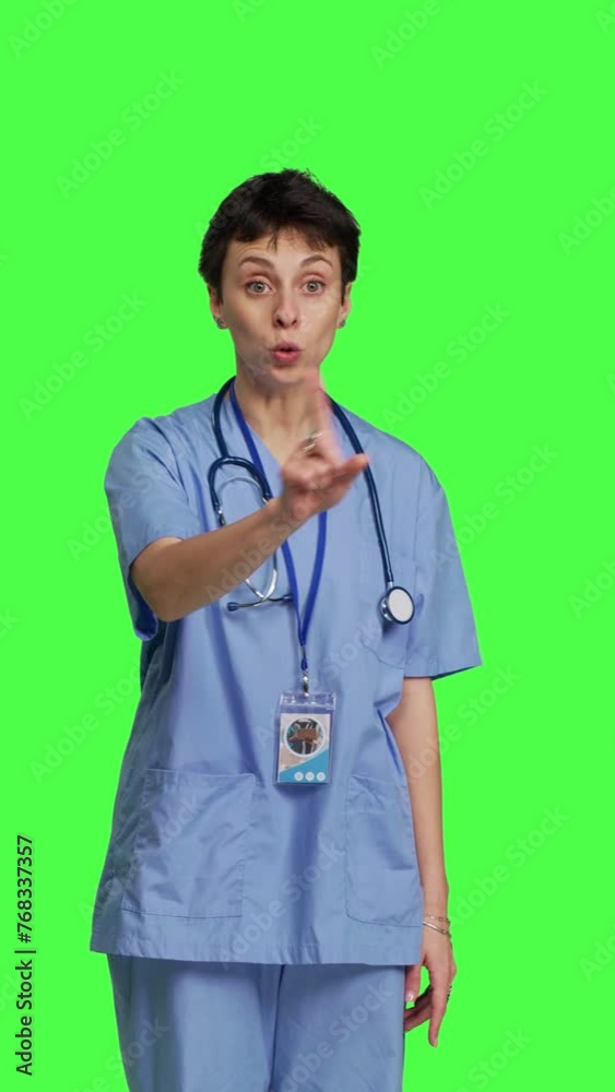 Front view Stressed furious nurse screaming at someone against greenscreen backdrop, showing rage and anger in studio. Aggressive upset medical assistant shouting and being dissatisfied. Camera B. Front view Stressed furious nurse screaming at someone against greenscreen backdrop, showing rage and anger in studio. Aggressive upset medical assistant shouting and being dissatisfied. Camera B.