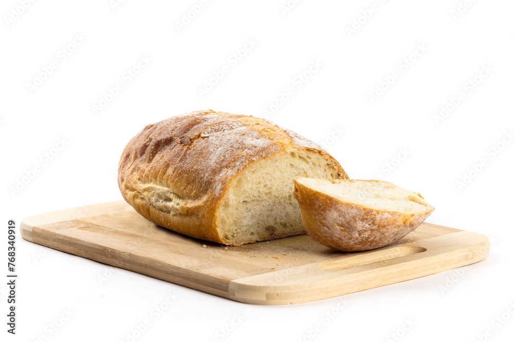 A whole loaf of artisanal crusty bread with the heel end cut off on a wooden cutting board isolated on white

