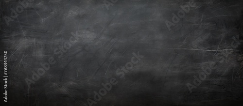 A detailed monochrome photography of a blackboard covered with chalk writings  capturing the intricate patterns and textures of the grey chalk against the dark brown surface