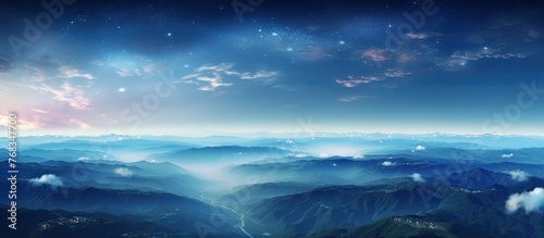 Beneath the electric blue sky, a mesmerizing view of the mountain range at night with a galaxy above. Cumulus clouds hover over the horizon, creating a dreamy atmosphere in the natural landscape