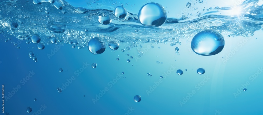 Bright and clear blue water surface with small bubbles floating on top in a close-up view, creating a serene and refreshing aquatic scene