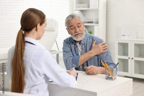 Arthritis symptoms. Doctor consulting patient with shoulder pain in hospital