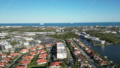 Aerial view of condos, homes, apartments, and hotels with cruise ships in the background in the Cape Canaveral area of Brevard County, Florida.  © Ryan Tishken