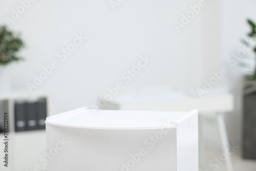 White ballot box on blurred background  closeup. Space for text
