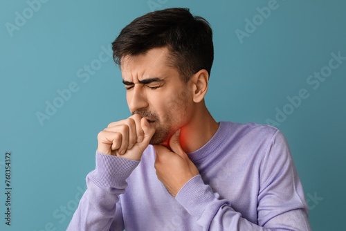 Coughing young man with sor...