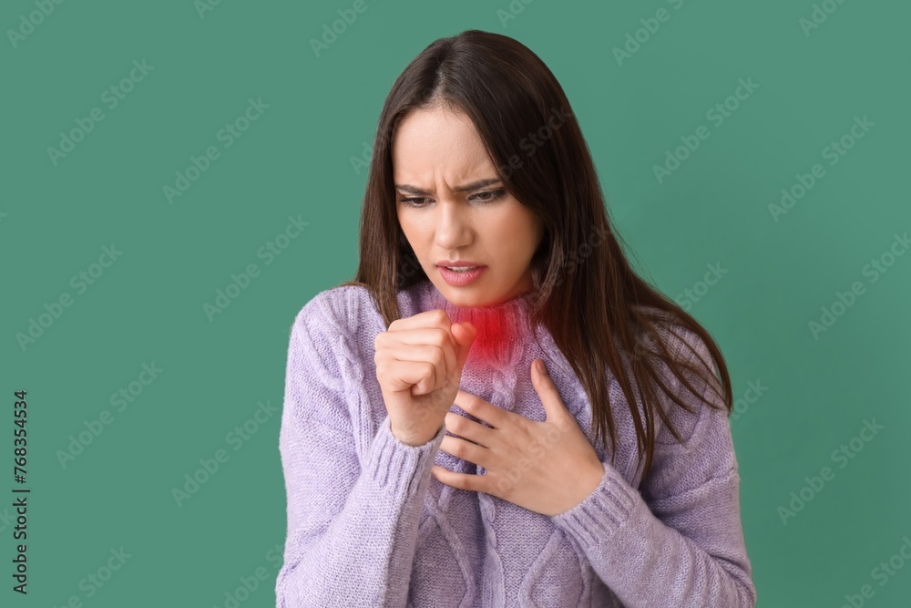 Coughing young woman with sore throat on green background Coughing young woman with sore throat on green background