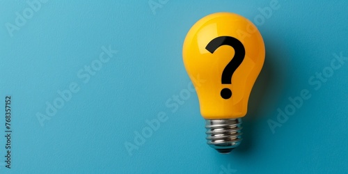 Light bulb with question mark symbol on blue background, concept of ideas and creativity photo