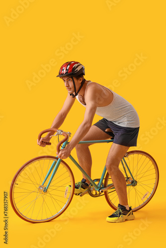 Young male cyclist riding b...