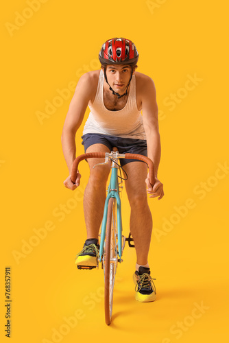 Young male cyclist riding b...