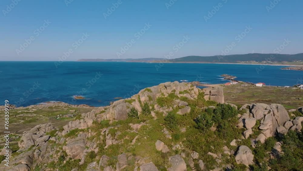 Country Houses On Sea Coast Revealed Behind Rocky Hill In Camariñas, A Coruña, Spain. drone flyby shot Country Houses On Sea Coast Revealed Behind Rocky Hill In Camariñas, A Coruña, Spain. drone flyby shot