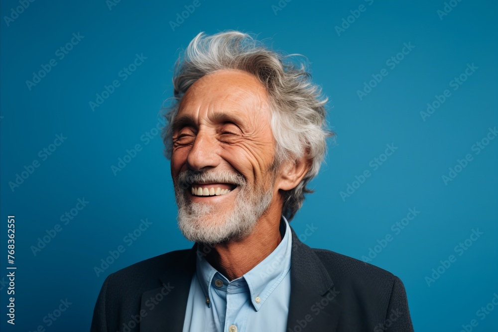 Portrait of smiling senior man. Isolated on blue background. Portrait of smiling senior man. Isolated on blue background.