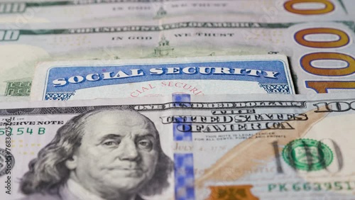 Social security card with one hundred dollar bills
