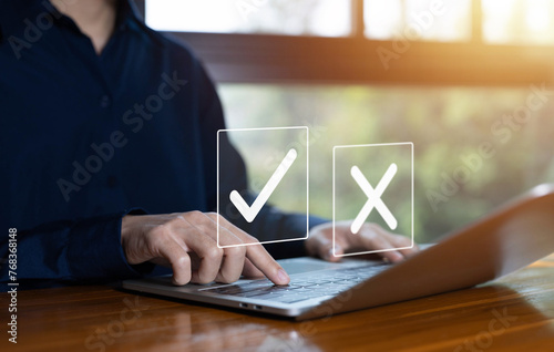 true and false symbols agreeing, check right and wrong marks on a laptop. concept decide to choose vote. yes or no decisions, and business options for difficult situations in dilemma.