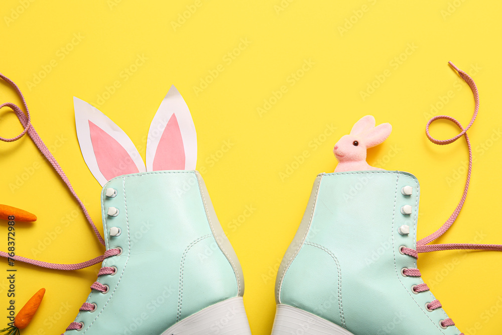 Vintage roller skates with bunny ears made of paper and carrots on yellow background. Easter celebration - obrazy, fototapety, plakaty 