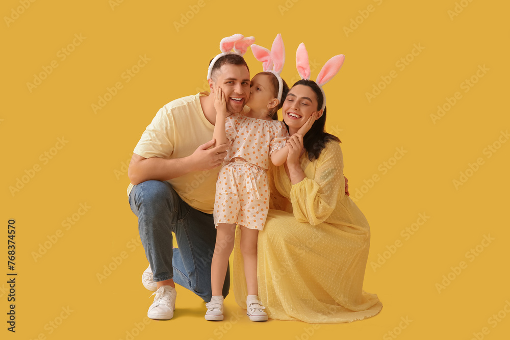 Happy family in Easter bunny ears on yellow background - obrazy, fototapety, plakaty 