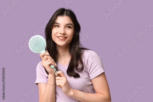 Smiling young woman holding...
