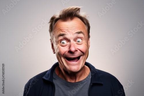 senior cool man with surprise facial expression. over grey background. © Chacmool