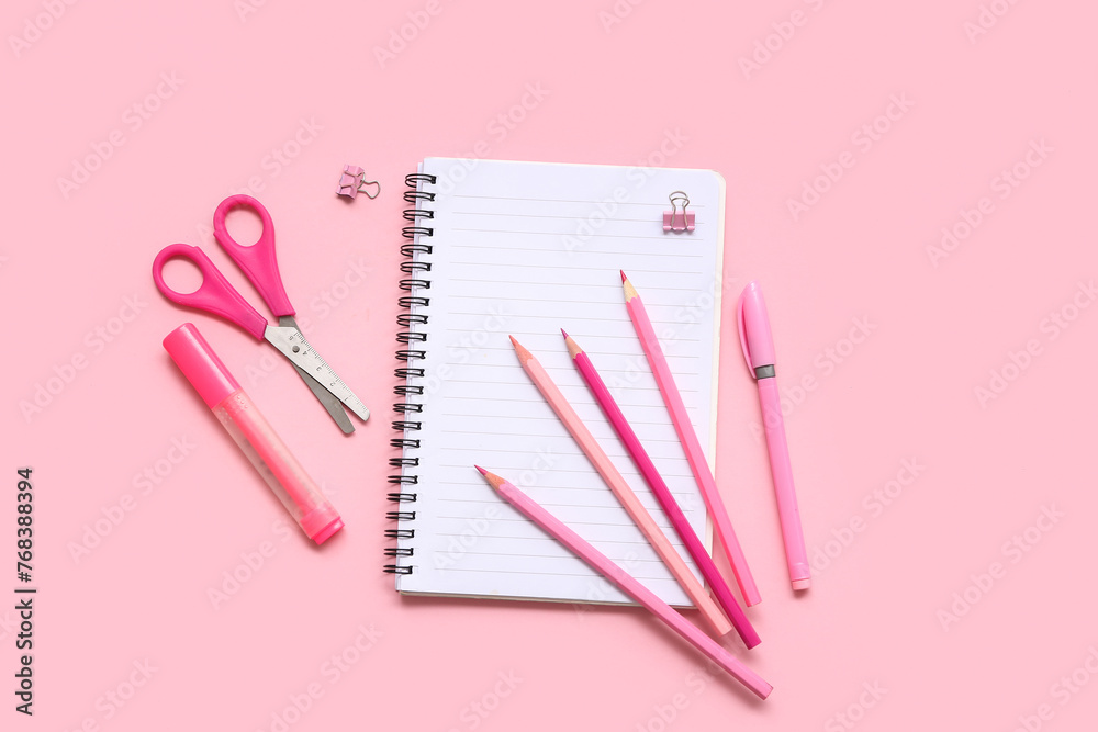 Notebook with pencils on pink background. Top view Notebook with pencils on pink background. Top view
