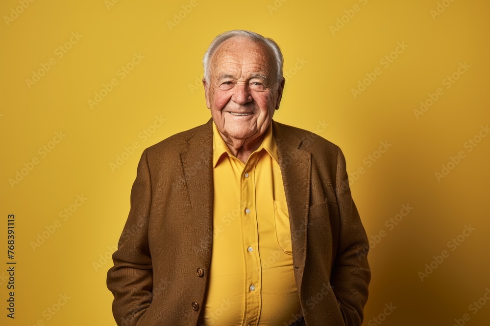 Portrait of a happy senior man posing on a yellow background. Portrait of a happy senior man posing on a yellow background.