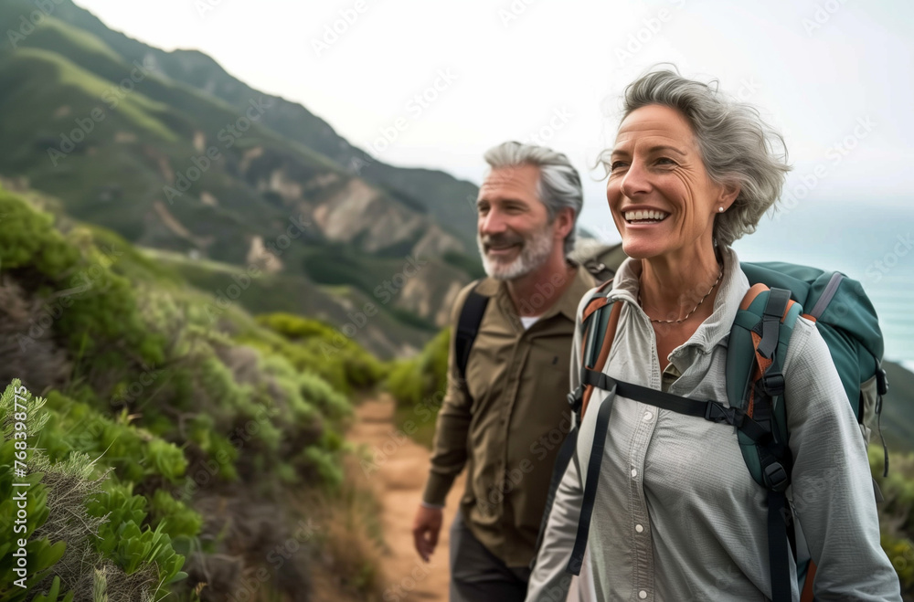 An elderly couple admires nature while hiking along the scenic Pacific coast