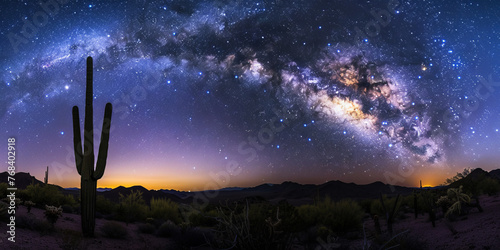 Vibrant panoramic night sky with the Milky Way galaxy over a silhouette of cacti in a desert landscape