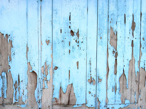 Old wooden plank wall painted blue and the surface is peeling off, Texture for add text or graphic design