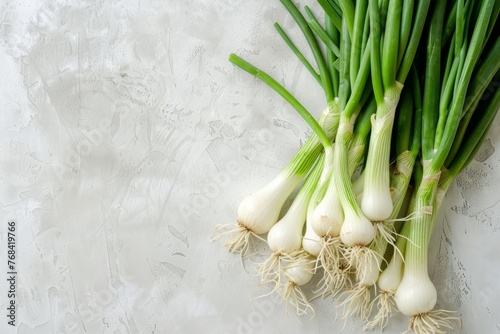 Bunch of green onions neatly arranged on top of a table