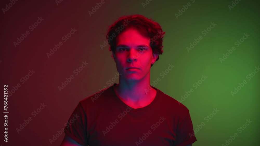 Portrait of Young Man Looking at Camera and Showing Gesture of Ok Indoors in Neon Room. Modern Lifestyle and 20s Youth of One Real Person Close Up. Cool Human and Feeling Good Sign or Good Deal Symbol Portrait of Young Man Looking at Camera and Showing Gesture of Ok Indoors in Neon Room. Modern Lifestyle and 20s Youth of One Real Person Close Up. Cool Human and Feeling Good Sign or Good Deal Symbol