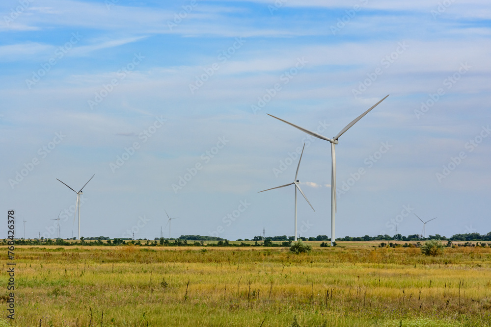 Wind turbines at the agricultural field. Clean energy. Ecological concept Wind turbines at the agricultural field. Clean energy. Ecological concept