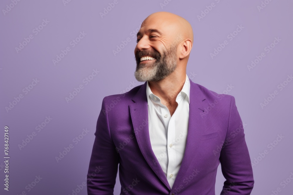 Portrait of a happy mature man with beard and mustache smiling against purple background Portrait of a happy mature man with beard and mustache smiling against purple background